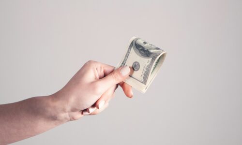 person holding 1 us dollar bill